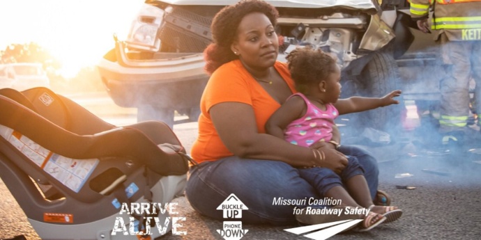 a mom and her child in front of a wrecked car