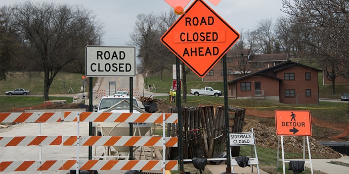 A photo showing multiple construction barricades alerting that a roadway and adjacent sidewalk are closed