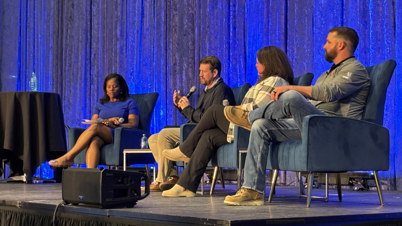 Four people speaking at a panel discussion