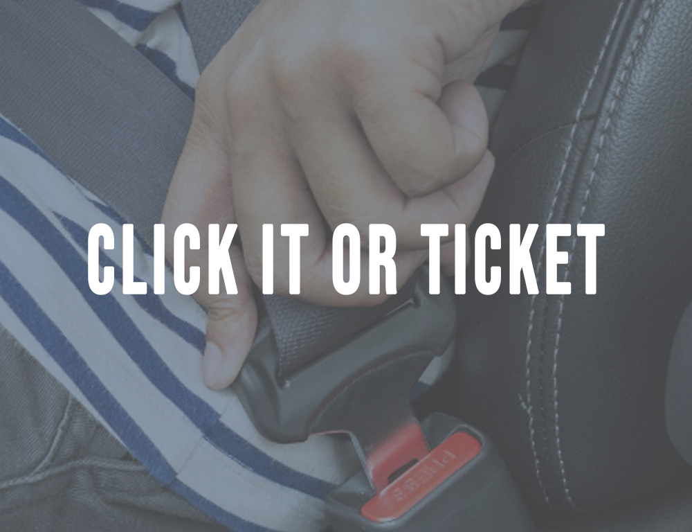 a hand buckling a seat belt