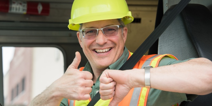 a modot employee flashes the buckle up phone down thumbs