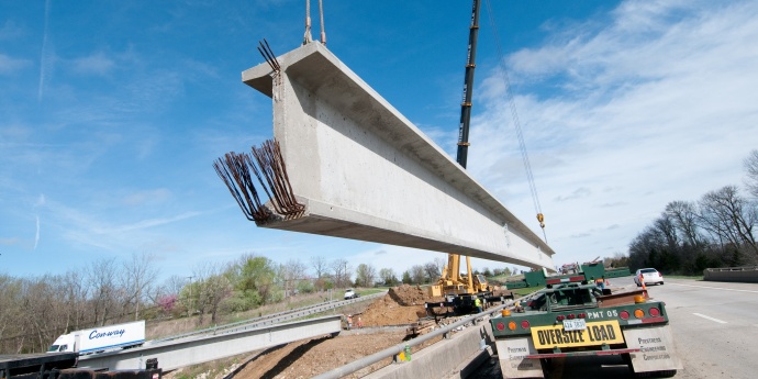 image of a beam being lifted into place during construction