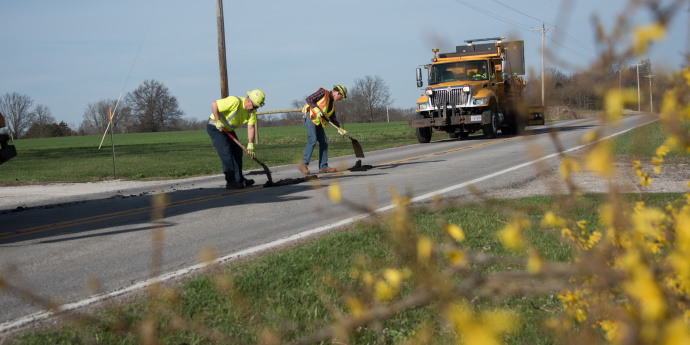 Road work, with two workers patching the road