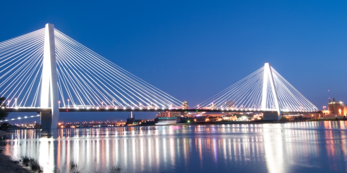 night bridge with city lights in the background