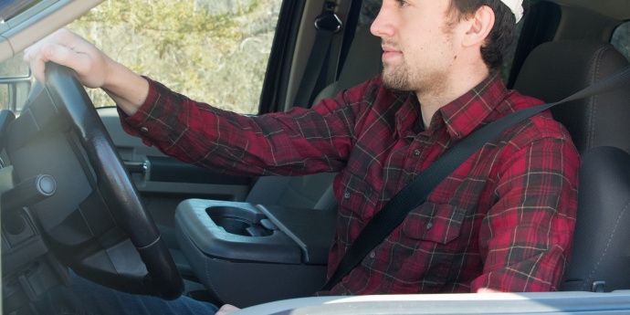 a young male wearing a seat belt