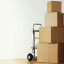 Image of moving boxes stacked on a moving dolly.