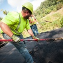 a crew spreads asphalt