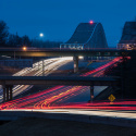 Night highway with traffic crossing bridges