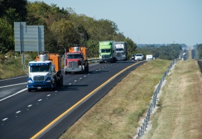 A line of four semis drive down a Missouri interstate