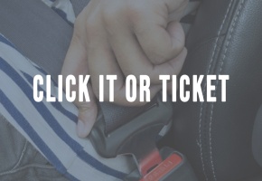 a hand buckling a seat belt