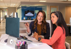 Two women working at a computer