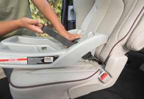 Person installing a car seat.
