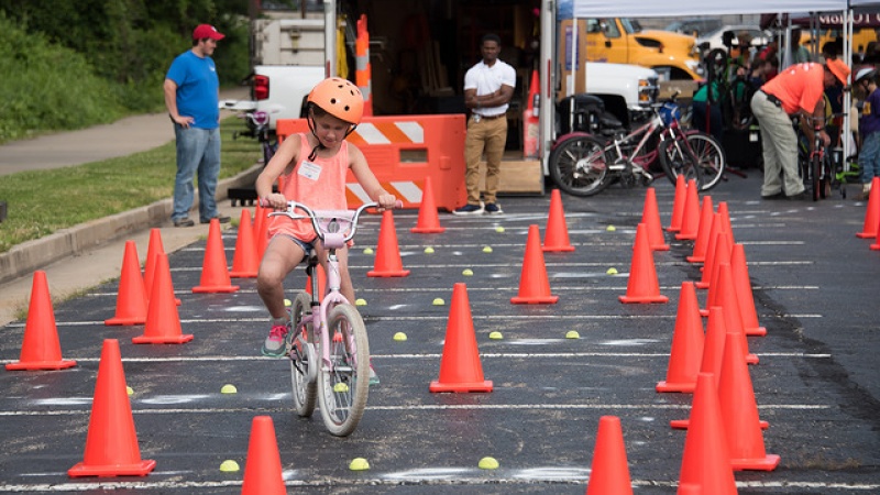 Girl safely navigating bicycle obstacle course