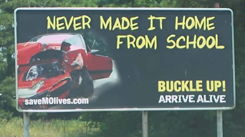 Billboard stating "Never made it home from school, buckle up, arrive alive."