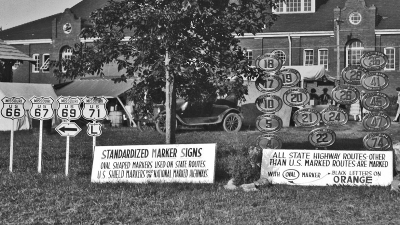 Photo of a display of standardized highway markers at the 1926 State Fair
