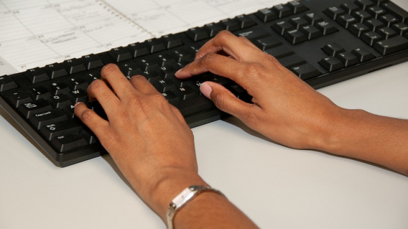 Employee typing at desk