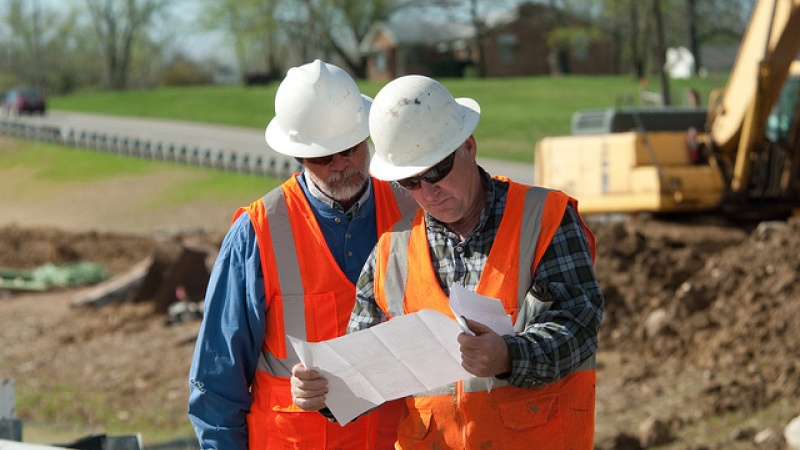 Workers studying plans