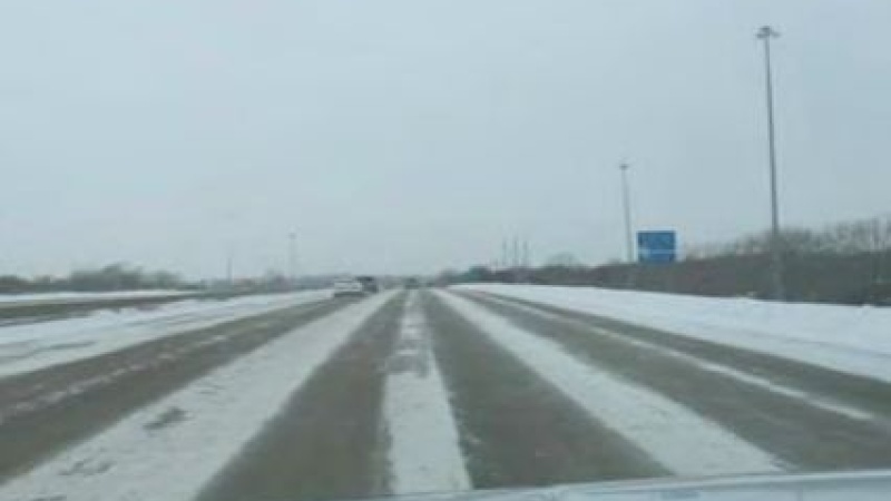 a highway partly covered in snow