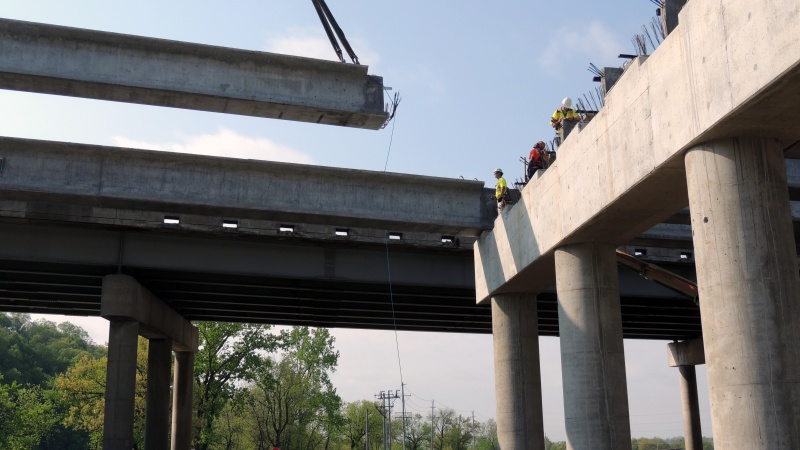 Crews place a girder over Yarnell Road as a part of the project.