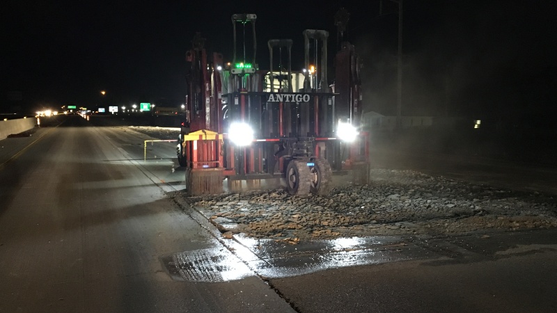Large machines break up the old Route 65 pavement