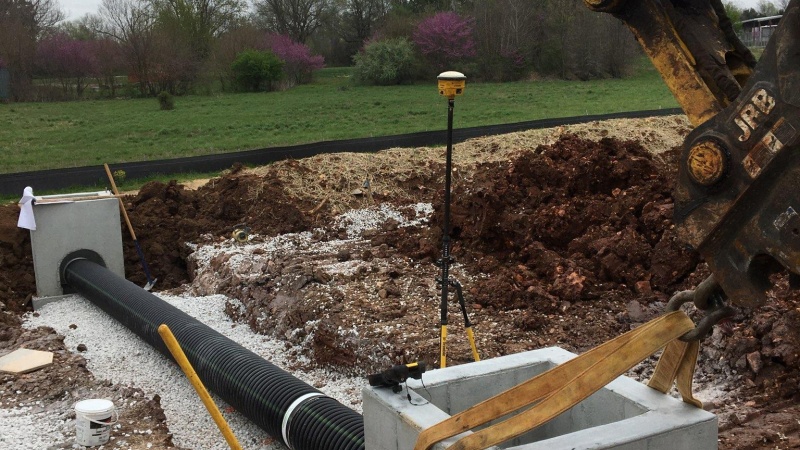 Crews installing storm drain structure