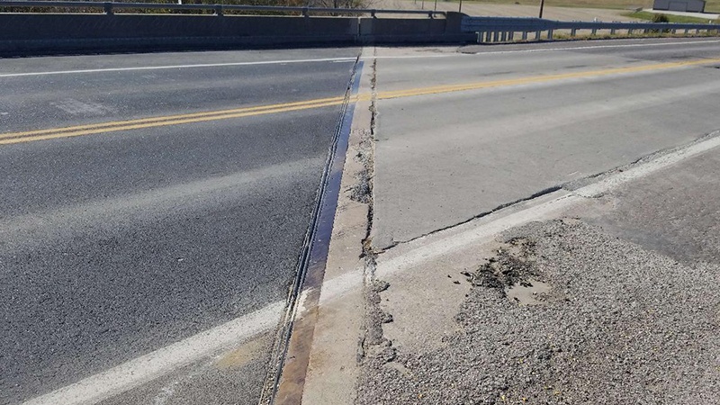 A view of the expansion joint on the north end of the Carroll County US Rte 24 bridge over BNSF RR showing the bridge joint on a diagonal