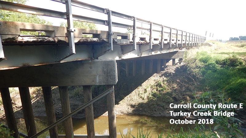 Profile view showing rail, supports and stream of Carroll County Route E Turkey Creek Bridge