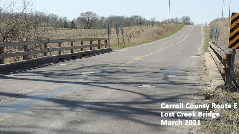 Photo showing deterioration on the asphalt driving surface of the Carroll County Route E Lost Creek Bridge
