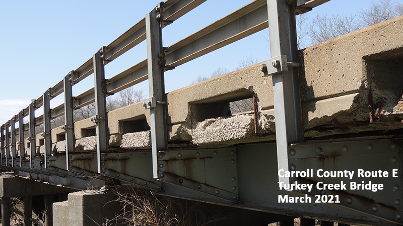 Profile of Carroll County Route E Turkey Creek Bridge showing railings and deterioration of concrete edge of bridge deck