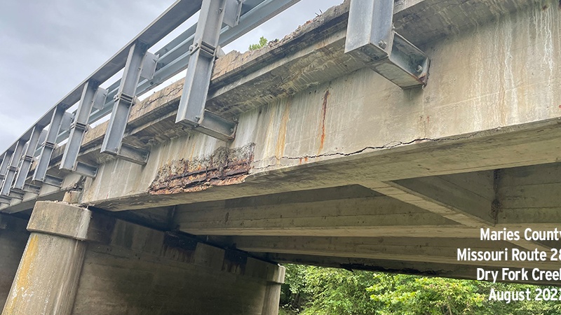 A photo showing spalls in the girder of the Maries County Route 28 Dry Fork Creek bridge, taken in 2022.