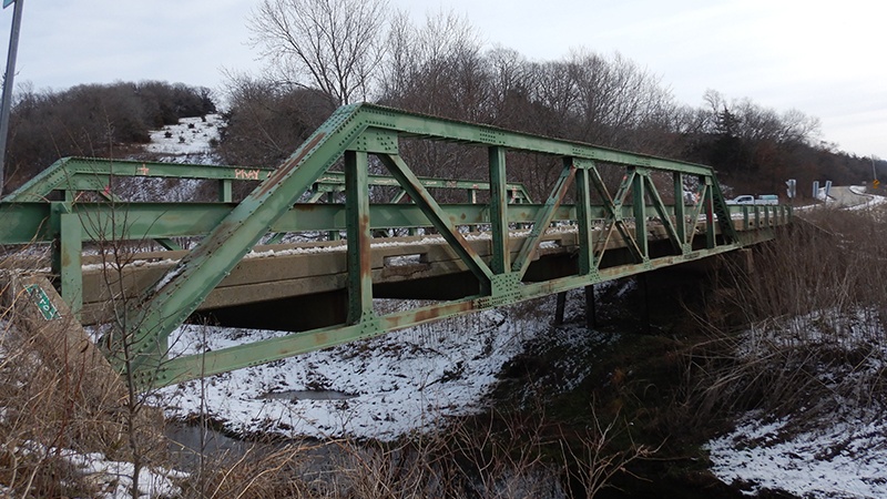 Photo from January 2024 showing the green truss structure on the side of the Cooper County Route HH Brush Creek Bridge.