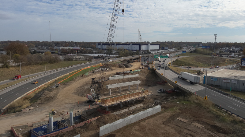 Crane working near bridge caps in interstate median