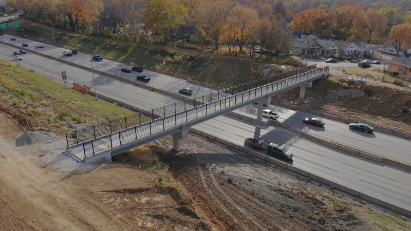 Aerial view of nearly-complete pedestrian bridge over highway