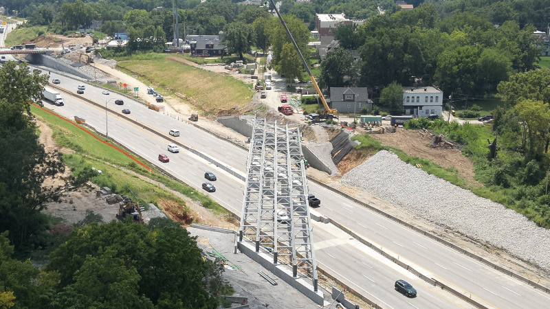 Aerial view of a city road bridge with girders installed over an active highway
