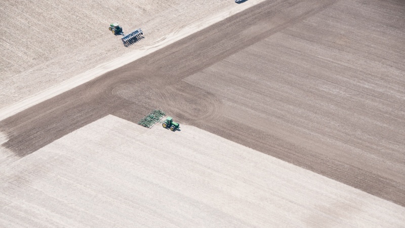 a bird's eye view of tractors working on a farm