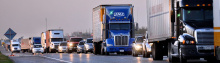 Semi Trucks in traffic on interstate highway